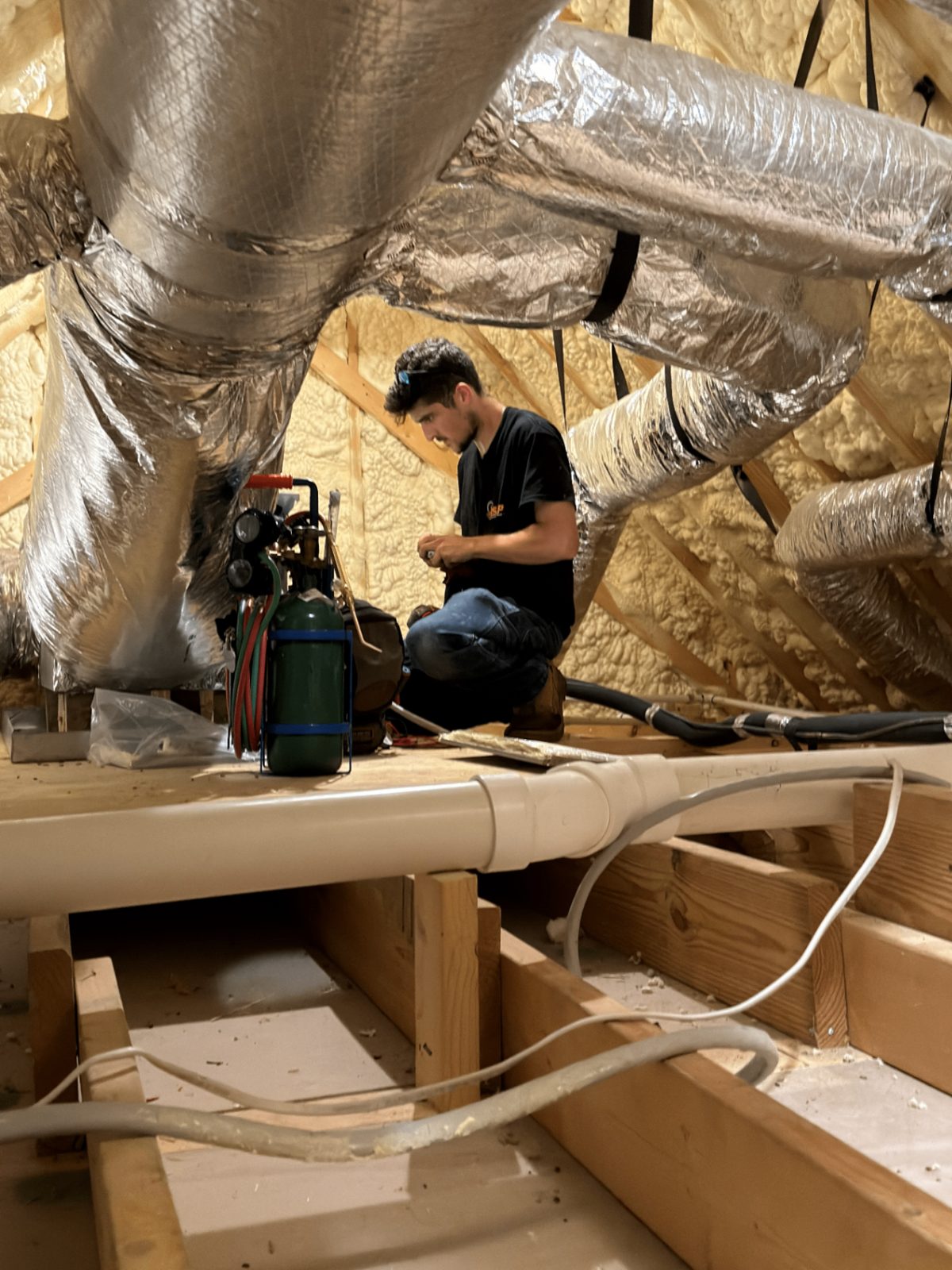 ASAP Heating and Air-Conditioning LLC technician working on insulated attic ductwork and an air handler connection in a Middle Tennessee home.