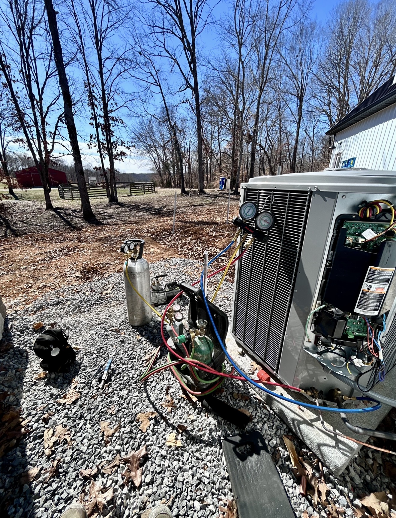 ASAP Heating and Air-Conditioning technician servicing a residential heat pump in Centerville, Tennessee.
